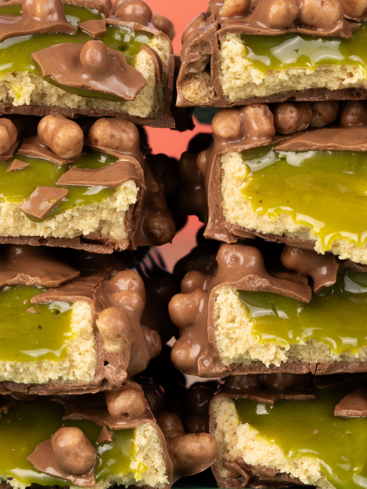 Barebells Pistachio Spread bars stacked showing pistachio filling, chocolate coating and crispy pearls